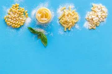Uncooked paste on blue table background top view mockup