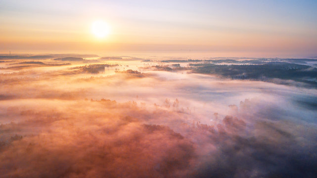 Summer sunrise and morning fog over woodland aerial panorama © NemanTraveler