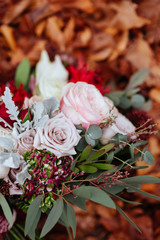 Obraz na płótnie Canvas Bridal Wedding Bouquet on Autumn foliage background, outdoor