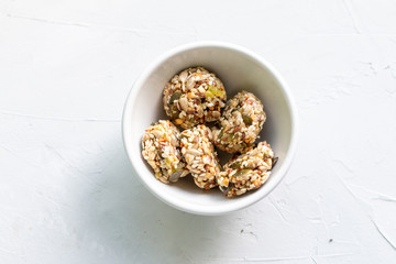 Homemade sweets energy balls made from superfoods like seeds, nuts and dried fruits. Healthy snack, raw dessert and superfood. With space for text
