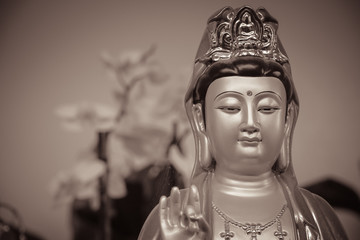 Statue of Kwan Yin ou Guan Yin Buddha in Sepia style, Goddess of Mercy and Compassion in the buddhist religion