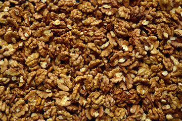 Heap of raw peelled organic walnuts. Top view with copy space.
