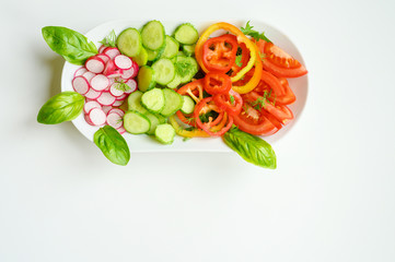Fresh salad in a white plate. Cut vegetables. Top view.