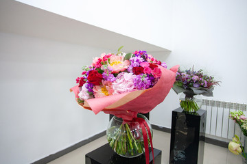 Close up view of beautiful flowers mix in the box. Unpacking and deliver roses. Small business. Floral carpet for Wallpaper. Bouquet of flowers in a glass vase...