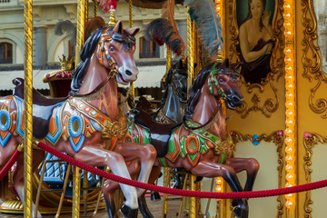 Fototapeta na wymiar Beautiful vintage retro merry-go-round carousel wooden horses