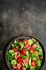Vegetable salad with salmon and salad leaves mix. Top view with copy space.