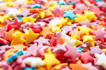 Sugar stars for baking decoration. Confectionery multi-colored topping closeup. Shallow depth of field