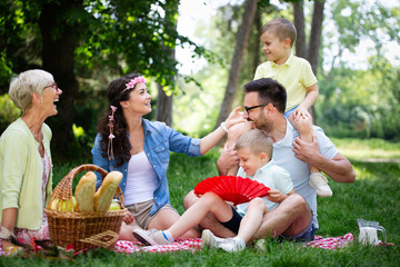 Fototapeta premium Young family with children having fun in nature