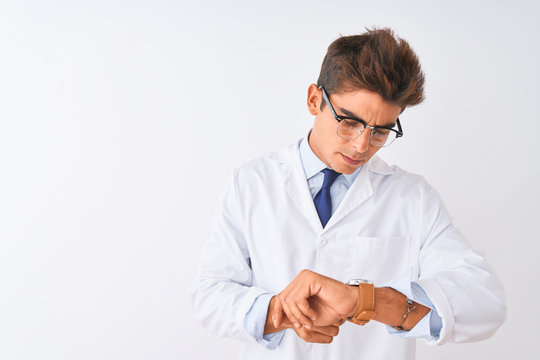 Young handsome sciencist man wearing glasses and coat over isolated white background Checking the time on wrist watch, relaxed and confident