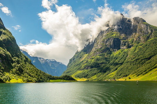 Green mountain peak above the small village in Naeroy fjord,  Aurlan, Sogn og Fjordane county, Norway