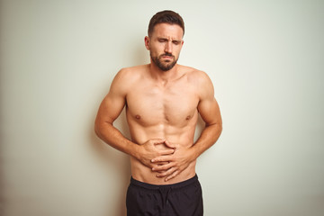Young handsome shirtless man over isolated background with hand on stomach because nausea, painful...