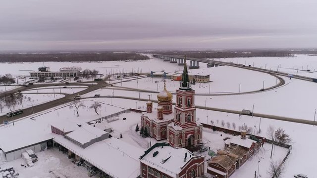 Aerial of bridge and car driving on the bridge, winter sunny day in Barnaul, Siberia, Russia.