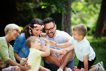 Fototapeta premium Happy family enjoying picnic in nature at summer