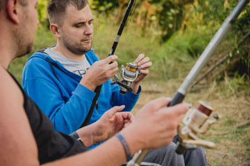 Handicapped men fishing at a lake. Wheelchair. Camping.