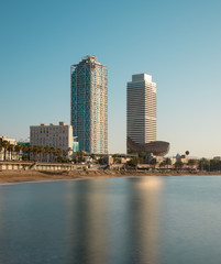 Fototapeta premium Reflection of two buildings on a beach in Barcelona (La Barceloneta).