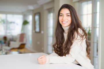 Beautiful brunette woman smiling cheerful with big smile, looking positive and happy