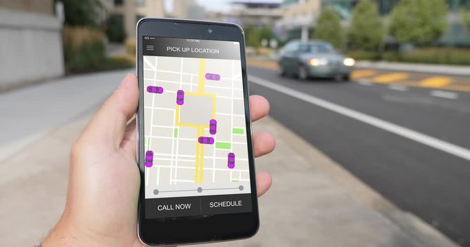 A man holds a smartphone running an ride sharing app. The screen shows nearby cars available. Fictional interface.  	