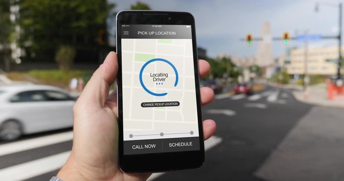 A man holds a smartphone running an ride sharing app. The screen reads Locating Driver. Fictional interface.	 	