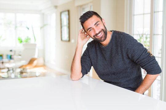 Handsome man smiling cheerful with a big smile on face showing teeth, positive and happy expression