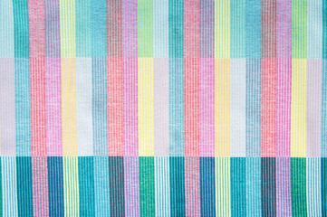 Colorful textile abstract background in a full frame close-up of woven layers