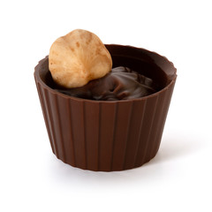 Small chocolate basket with cream and nut on a white background