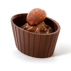 Small chocolate basket with cream and nut on a white background