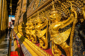 Emerald buddha temple golden pagoda blue sky with cloud sightseeing in Bangkok