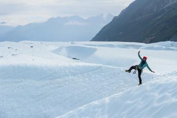 Glacier guide dancing in crampons on one leg.