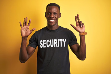 African american safeguard man wearing security uniform over isolated yellow background showing and...