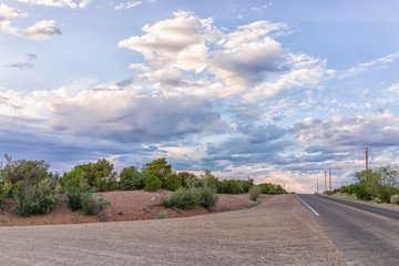 Fototapeta premium Intersection of Encantado drive and Bishops Lodge Road with nobody in Santa Fe, New Mexico during evening sunset and mountains