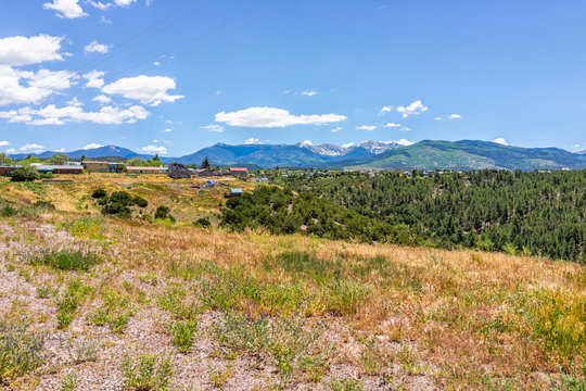 Landscape view during summer from High Road to Taos of mountains and village called Truchas
