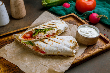 roll with chicken on the Board on dark rustic background