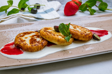 cheesecakes from cottage cheese on grey background