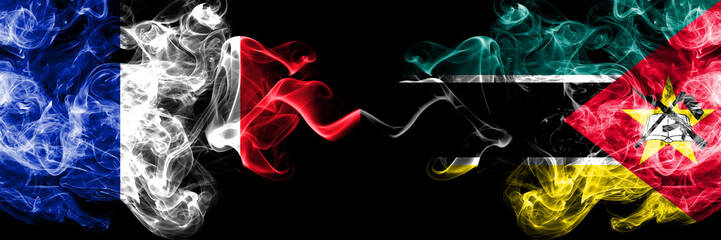France vs Mozambique, Mozambican smoky mystic flags placed side by side. Thick colored silky abstract smoke banner of French and Mozambique, Mozambican
