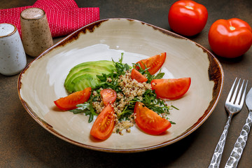 Quinoa side dish with onions and vegetables on wooden table