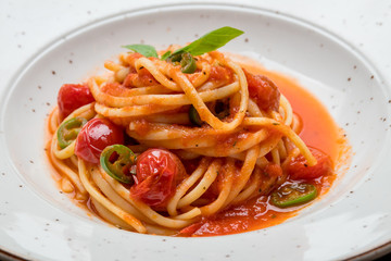 Pasta linguini arabiata on old wooden table