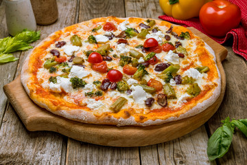 Pizza with vegetables vegetarian on old wooden table
