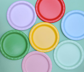 Colorful paper plates on light background.