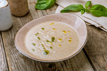 Cream soup of mushrooms on old wood table