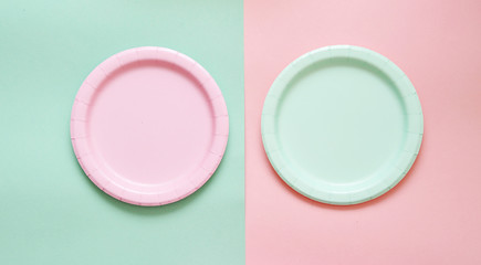 Colorful paper plates on light background.