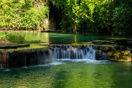 Waterfall in deep tropical rainforest with green tree © themorningglory