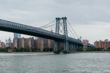 Fototapeta na wymiar View on Williamsburg bridge and Manhattan downtown from Domino Park in Williamsburg, Brooklyn