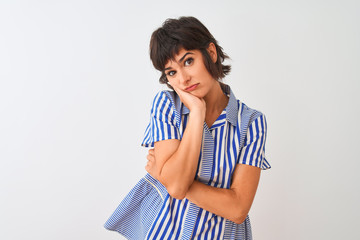 Young beautiful woman wearing blue striped shirt standing over isolated white background thinking looking tired and bored with depression problems with crossed arms.