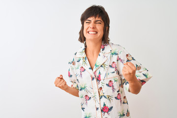 Beautiful woman on vacation wearing summer casual shirt over isolated white background very happy and excited doing winner gesture with arms raised, smiling and screaming for success. 