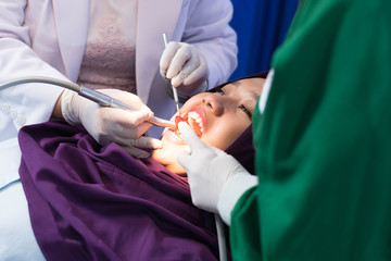 close up Portrait of hijab woman have examining in dentist chair