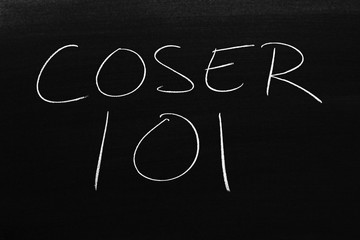 The words Coser 101 on a blackboard in chalk.  Translation: Sewing 101