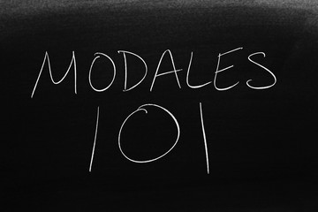 The words Modales 101 on a blackboard in chalk.  Translation: Manners 101