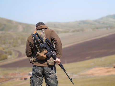 Military Man With Sniper Rifle SVD, View From The Back.