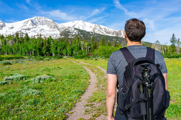 Thomas Lakes Hike with man looking at snow view of Mt Sopris, Carbondale, Colorado and meadow field...