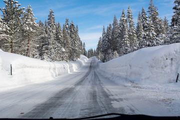 Frozen road highway 88 towards Carson Pass featuring 5 feet of snow on the shoulder